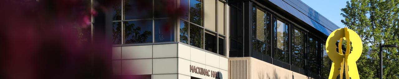 View of Mackinac Hall and yellow statue out front
